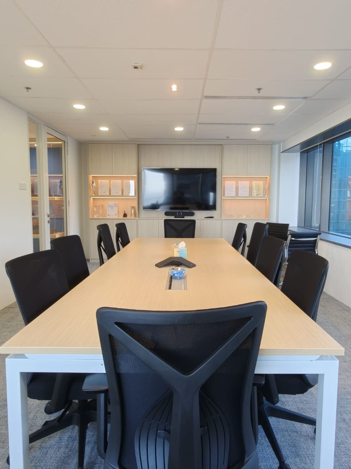 Boardroom with oak table and cabinet wall, OUE Downtown 1