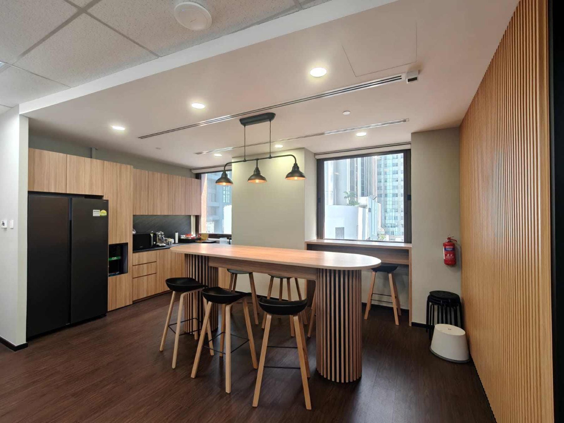 Pantry with long high table and timber joinery, 78 Shenton Way