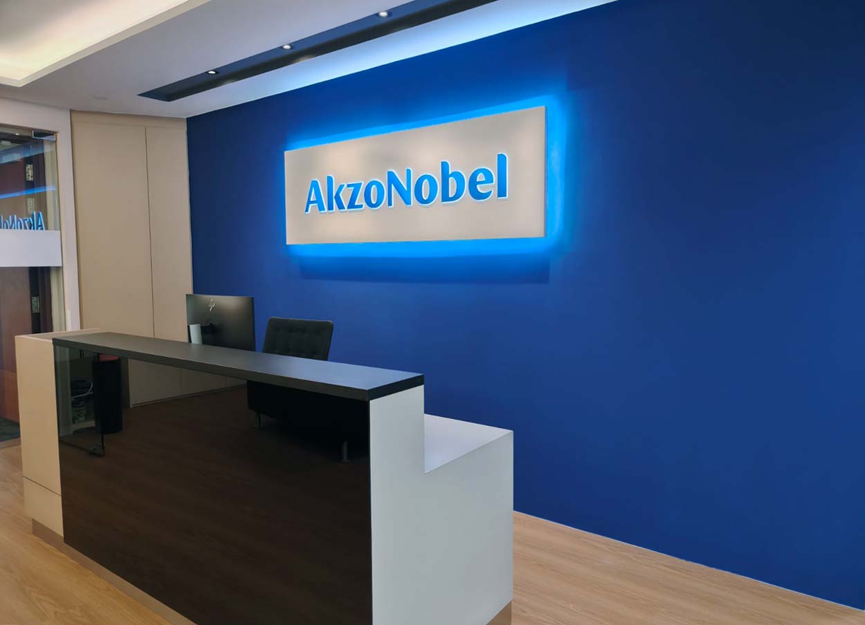 Reception desk against a blue AkzoNobel feature wall. The Signature, AkzoNobel office.