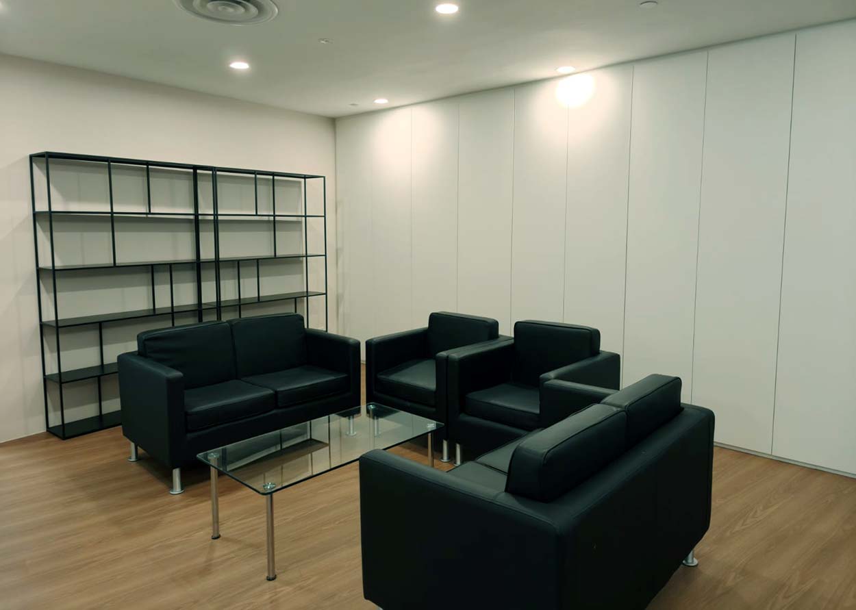 Black lounge seating with open shelving. The Signature, AkzoNobel office.