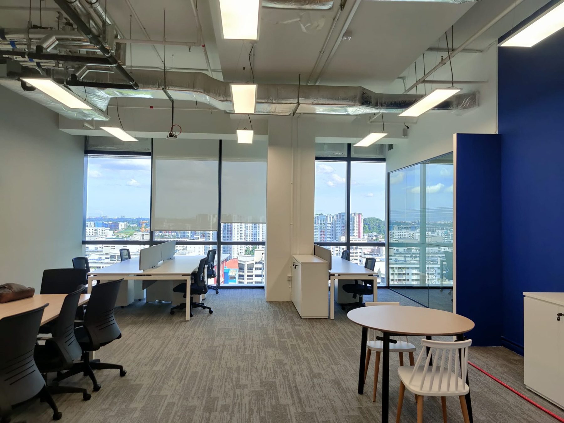 Open office with exposed ceiling and city views at Woodsquare Tower